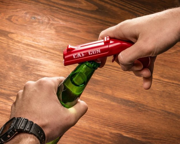 Bottle opener with cap gun